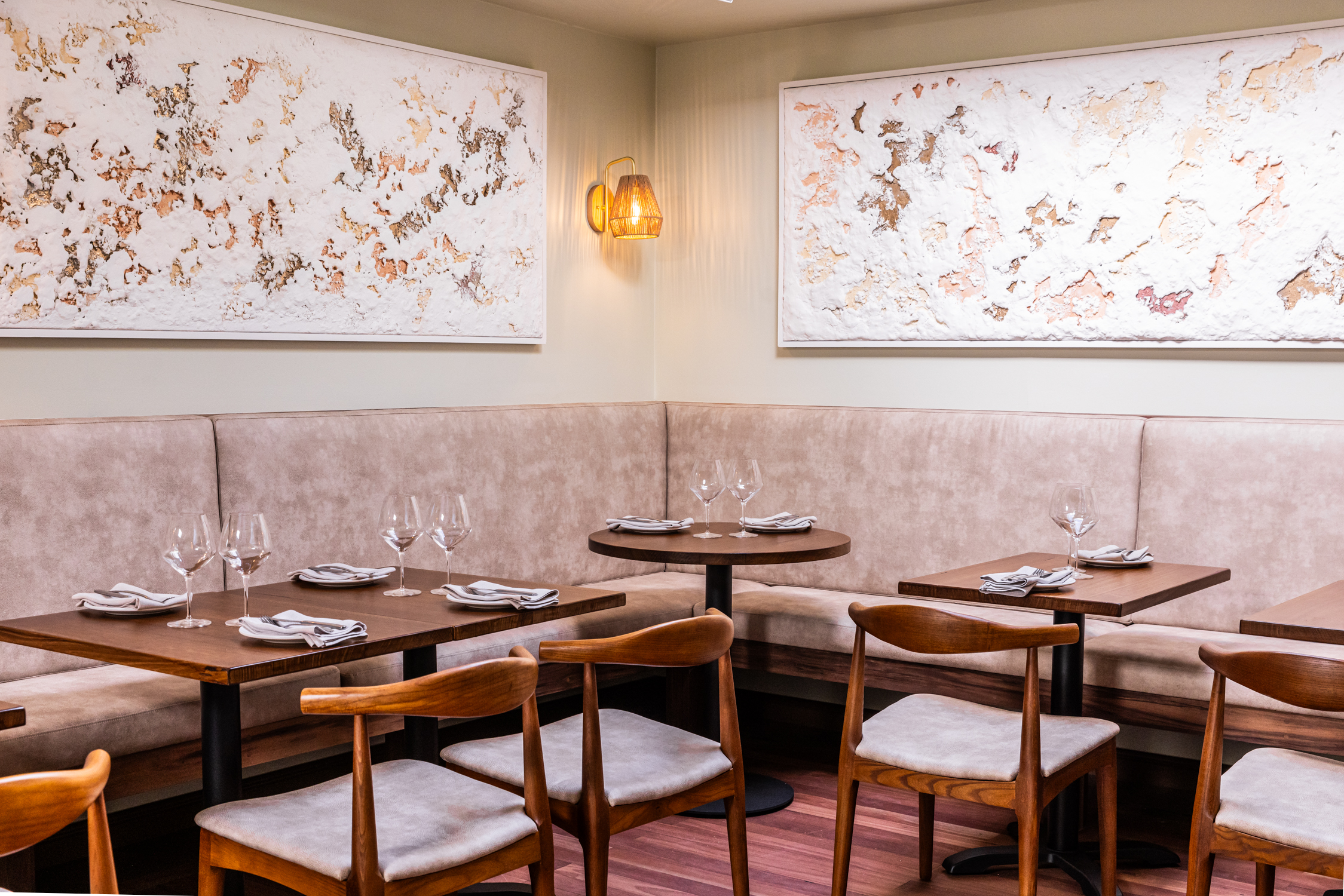 The dining room at OUZO — elegant banquette seating