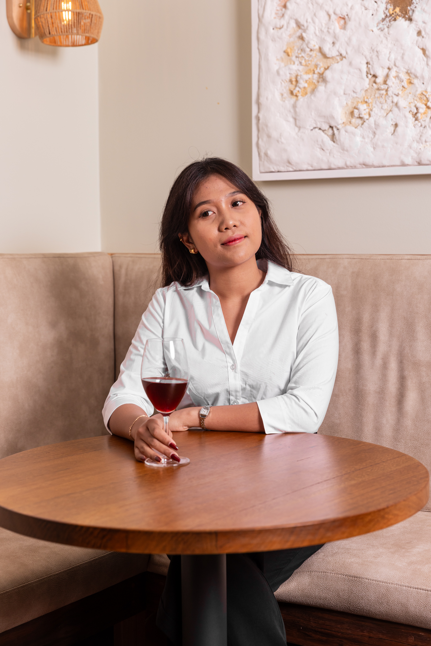 Guest enjoying a glass of red wine in the dining room