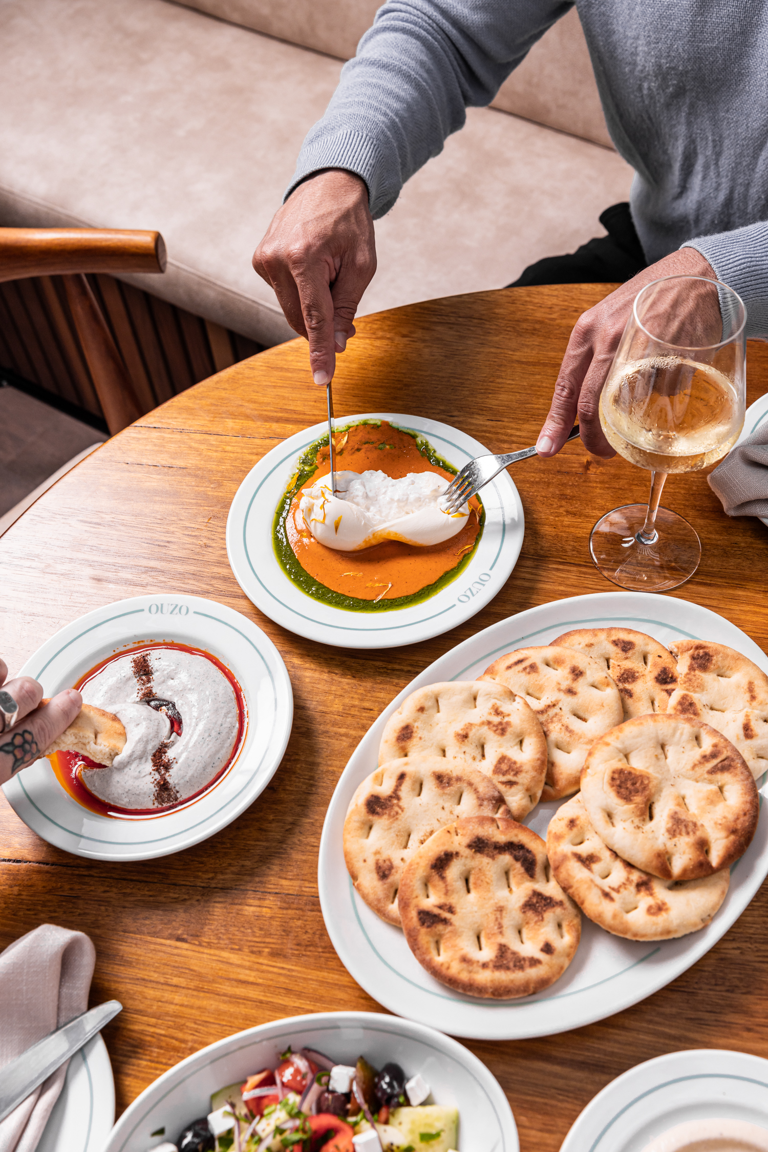 Burrata with red capsicum, pita bread and shared dips