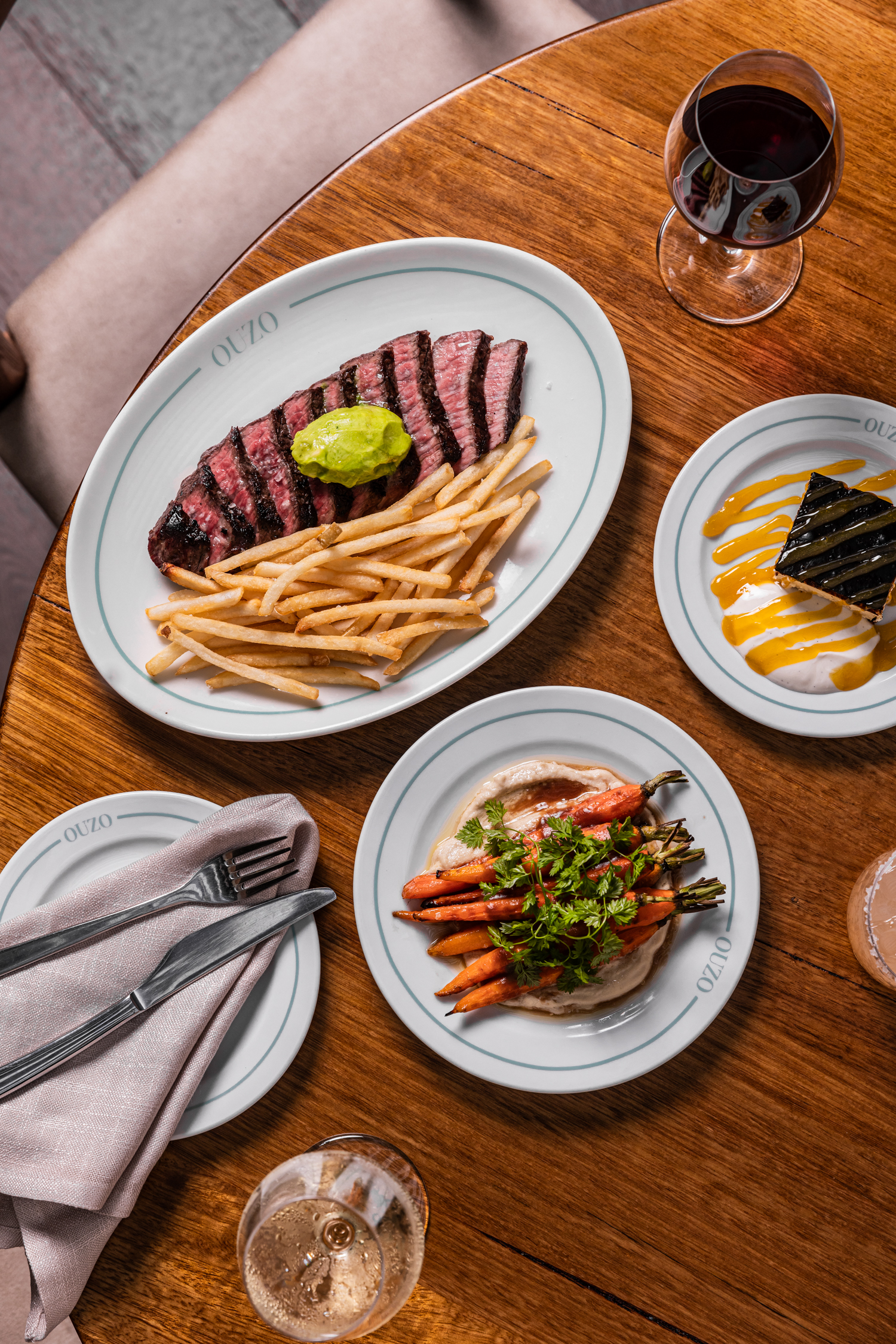 Woodfire-cooked steak with fries and herb butter